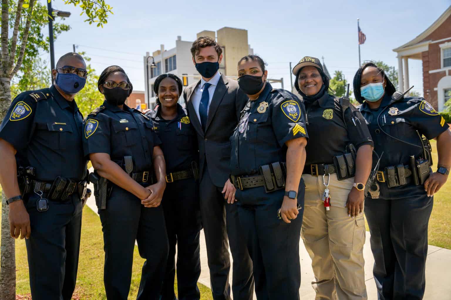 Senator Ossoff posing with six East Point, Georgia police officers.